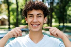 Happy Teen boy showing his braces smile