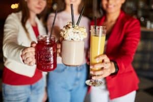 women holding halloween drinks in hand