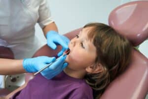 kids getting checked by orthodontist